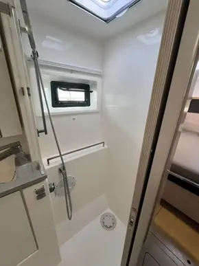 Modern shower area in 2019 Leopard 45 yacht with skylight and window.
