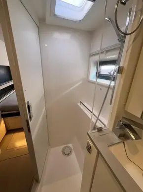 Modern bathroom in 2019 Leopard 45 yacht with skylight and shower.