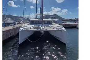 2020 Lagoon 46 catamaran docked under clear blue sky.