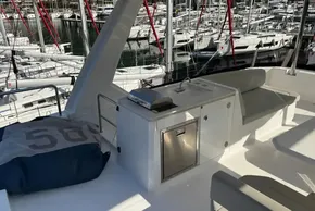 2024 Leopard 40 Powercat yacht interior with seating and kitchenette in marina setting.