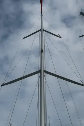 Mast of 2018 Beneteau Oceanis 51.1 sailboat against cloudy sky.