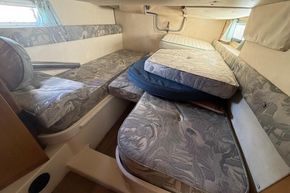 Interior cabin of 1991 Sealine 290 Ambassador with patterned cushions and compact layout.