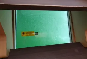 View through Lagoon 42 catamaran window, 2020 model, with safety warning sticker.