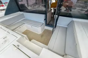 Spacious seating area on a 2020 Leopard 45 catamaran with cushioned benches and wooden flooring.