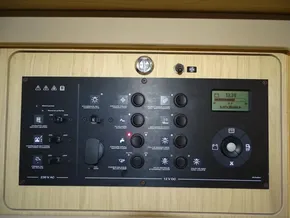 Control panel of a 2017 Beneteau Oceanis 45 sailboat, featuring various switches and a digital display.