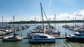 Marina with Leopard 50 yacht, 2022 model, docked among various boats under a clear blue sky.