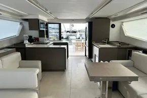 Luxurious interior of 2022 Leopard 53 Powercat yacht with modern kitchen and seating area.