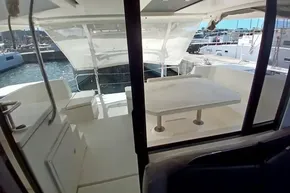 2018 Leopard 45 yacht cockpit with table, seating, and marina view.
