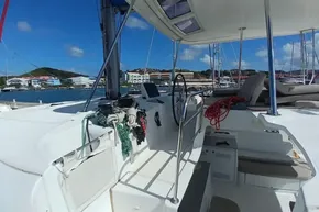 Cockpit of 2020 Lagoon 46 catamaran docked at marina under clear blue sky.