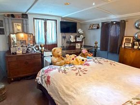 The large bedroom offers direct access to the front extenal area, via double doors.