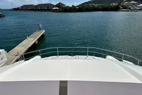 2025 Robertson and Caine Leopard 46 Powercat docked by scenic waterfront.