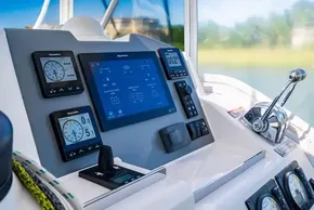 Control panel of a 2022 Leopard 50 yacht with navigation displays and throttle lever.
