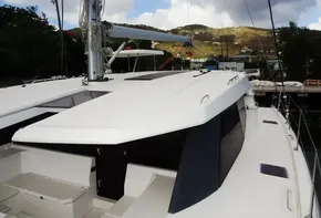 2017 Leopard 45 catamaran docked with scenic hillside background.