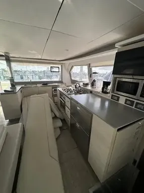 Modern kitchen interior of 2020 Leopard 50 yacht with sleek appliances and ample seating.