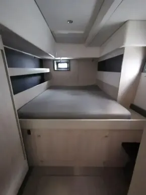 2017 Leopard 51 Powercat cabin with bed and small window.