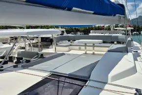 Luxurious 2021 Leopard 45 catamaran with spacious deck and seating area in marina.
