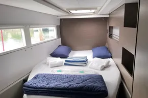Luxurious cabin interior of 2022 Leopard 45 yacht with neatly arranged bedding.