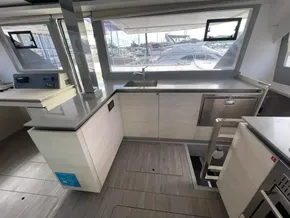 Modern kitchen interior on a 2020 Leopard 50 yacht, featuring sleek countertops and large windows.