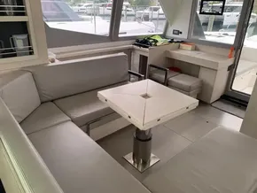 Modern interior of 2021 Leopard 45 yacht with sleek seating and table.