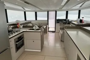 Interior of 2025 Robertson and Caine Leopard 46 Powercat, featuring modern kitchen and seating area.