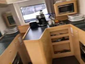 Modern kitchen area inside a 2020 Lagoon 42 catamaran, featuring appliances and ample counter space.