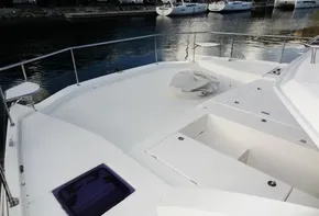 2018 Leopard 43 Powercat bow deck with storage compartments and waterfront view.