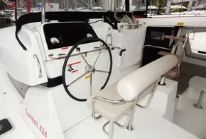 Helm station of 2020 Lagoon 42 catamaran with steering wheel and navigation instruments.