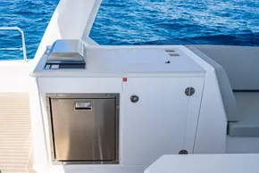 Outdoor kitchen on 2025 Leopard 40 Powercat yacht with stainless steel appliances and ocean view.