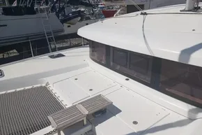 2024 Lagoon 42 catamaran deck with netting and seating, docked at marina.