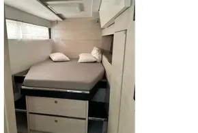 Modern bedroom interior in 2021 Leopard 50 yacht, featuring a cozy bed and sleek storage.