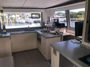 Modern kitchen interior on a 2021 Leopard 45 yacht, featuring sleek countertops and appliances.