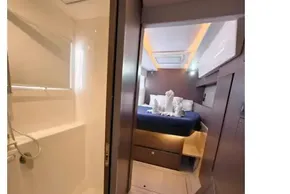Luxurious interior of 2021 Leopard 50 yacht featuring modern bathroom and cozy bedroom.