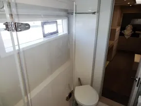 Bathroom interior of 2017 Leopard 43 Powercat with window and toilet.