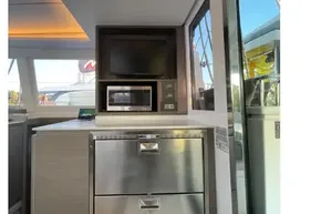Modern kitchen area on 2022 Leopard 42 yacht with stainless steel appliances.