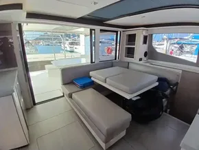 Interior of 2019 Leopard 45 catamaran with modern seating and marina view.