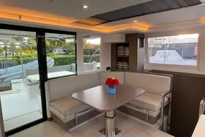 Luxurious interior of 2022 Leopard 42 yacht with elegant seating and table arrangement.