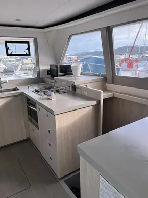 Modern kitchen interior on 2019 Leopard 45 catamaran with marina view.