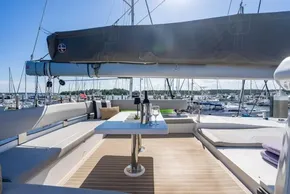 Luxurious 2022 Leopard 50 yacht deck with seating, table, and marina view.