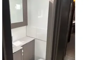 Compact modern bathroom in 2025 Leopard 46 yacht, featuring sleek design and efficient use of space.