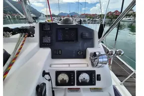 Helm of a 2020 Leopard 45 catamaran with navigation instruments and marina view.