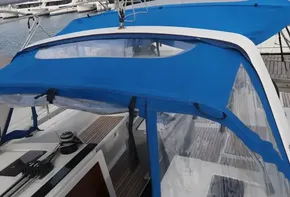 Beneteau Oceanis 41.1 sailboat, 2019 model, with blue canopy in marina.