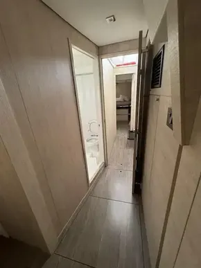 Modern interior of 2020 Leopard 50 yacht with sleek wood paneling and compact bathroom.