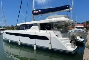 2020 Leopard 50 catamaran docked at marina with blue sky background.