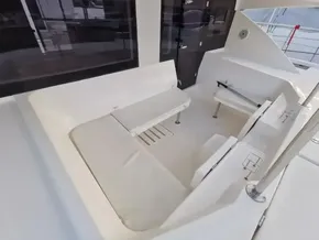 2017 Leopard 51 Powercat seating area with white cushions and table.