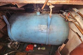 Blue tank in the engine room of a 1926 Dutch Barge Luxemotor.