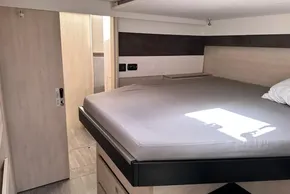 Interior of a 2021 Leopard 50 yacht cabin with a bed and sliding door.