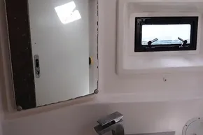Bathroom interior of 2017 Leopard 48 yacht with mirror and window.