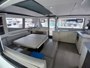 Spacious interior of 2019 Leopard 45 catamaran with modern seating and kitchen area.