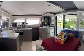 Luxurious interior of 2022 Leopard 45 yacht with modern kitchen and dining area.