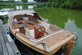 2026 Enkhuizensloep 615 boat with wooden deck, docked on a serene green river.